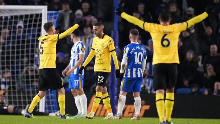 Chelsea's Thiago Silva, right, and Chelsea's Jorginho, left, celebrate after Chelsea's Hakim Ziyech, center, scoring his side's opening goal during the English Premier League soccer match between Brighton and Chelsea at the Falmer stadium in Brighton, England, Tuesday, Jan. 18, 2022. (AP Photo/Matt Dunham)