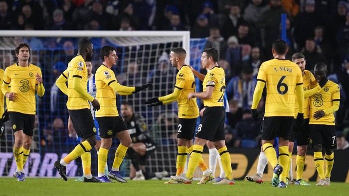 Chelsea's Hakim Ziyech, center, celebrates with teammates after scoring his side's opening goal during the English Premier League soccer match between Brighton and Chelsea at the Falmer stadium in Brighton, England, Tuesday, Jan. 18, 2022. (AP Photo/Matt Dunham)