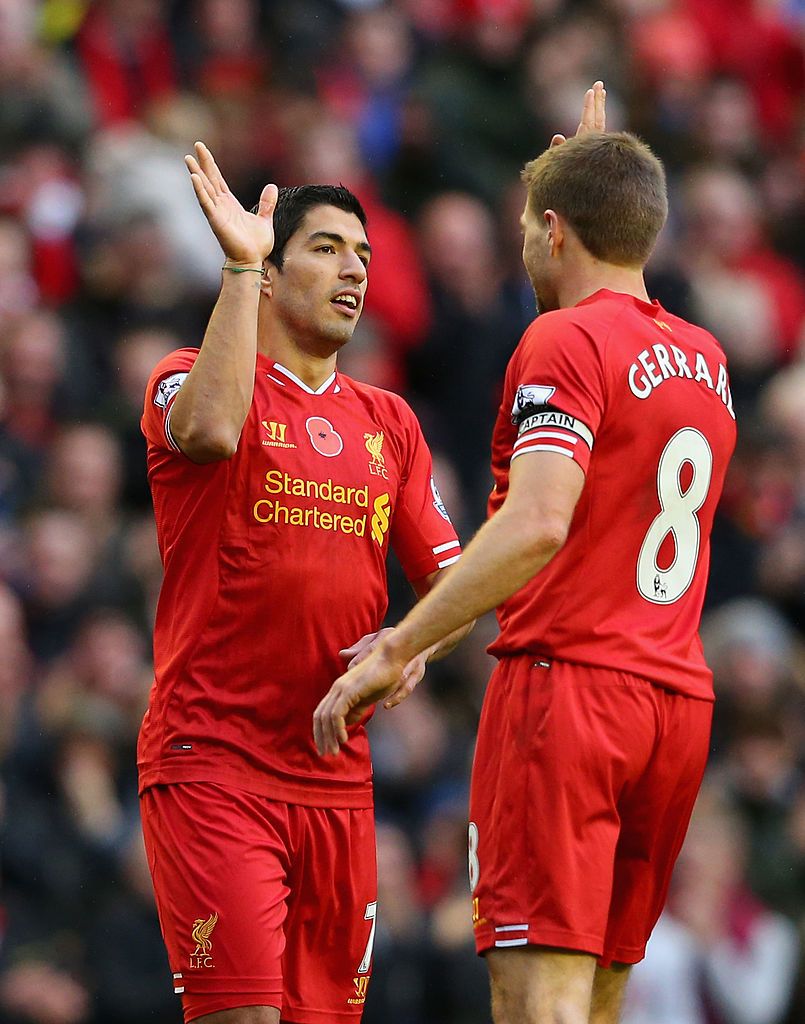 LIVERPOOL, ENGLAND - NOVEMBER 09:  Luis Suarez of Liverpool celebrates scoring the third goal with his team-mate Steven Gerrard during the Barclays Premier League match between Liverpool and Fulham at Anfield on November 9, 2013 in Liverpool, England.  (Photo by Alex Livesey/Getty Images)