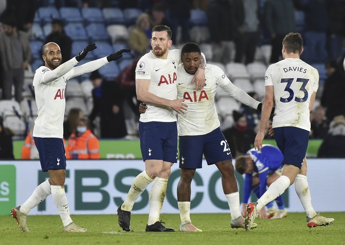 Tottenhams Lucas Moura, left, Tottenhams Pierre-Emile Hojbjerg,Tottenhams Steven Bergwijn,Tottenhams Ben Davies celebrate their victory during the English Premier League soccer match between Leicester City and Tottenham Hotspur at King Power stadium in Leicester, England, Wednesday, Jan. 19, 2022. (AP Photo/Rui Vieira)