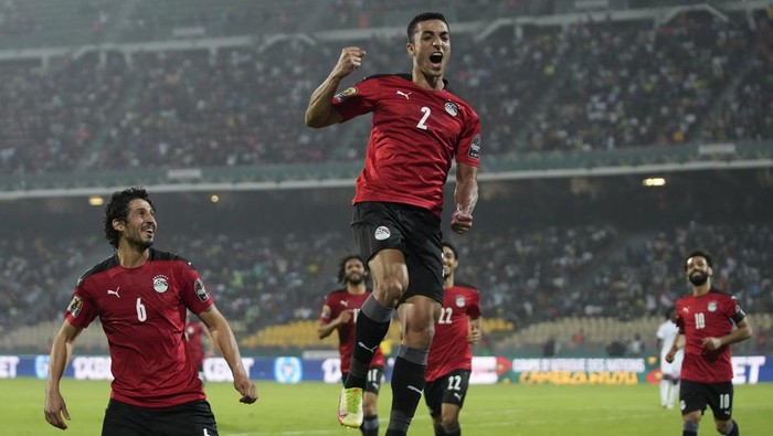 Egypts Mohamed Abdel-Moneim, middle, jumps as he celebrates with teammates after scoring his teams first goal, during the African Cup of Nations 2022 group D soccer match between Egypt and Sudan at the Ahmadou Ahidjo stadium in Yaounde, Cameroon, Wednesday, Jan. 19, 2022. (AP Photo/Themba Hadebe)
