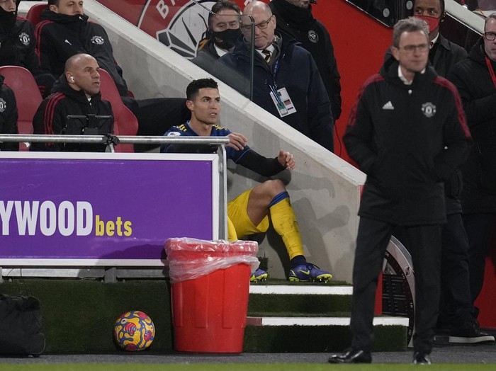 Manchester United's Cristiano Ronaldo sits watching the game after being substituted during an English Premier League soccer match between Brentford and Manchester United at the Brentford Community Stadium in London, Wednesday, Jan. 19, 2022. (AP Photo/Matt Dunham)