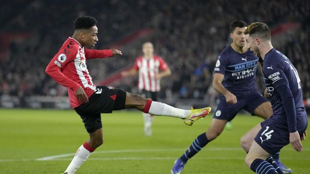 Southampton's Kyle Walker-Peters, left, scores the opening goal during the English Premier League soccer match between Southampton and Manchester City at St Mary's stadium in Southampton, England, Saturday, Jan. 22, 2022. (AP Photo/Kirsty Wigglesworth)