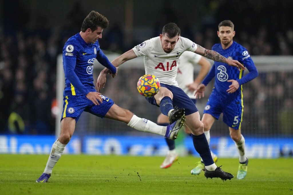 Chelsea's Hakim Ziyech, right, jumps for the ball with Tottenham's Ben Davies during the English Premier League soccer match between Chelsea and Tottenham Hotspur at Stamford Bridge stadium in London, England, Sunday, Jan. 23, 2022. (AP Photo/Kirsty Wigglesworth)