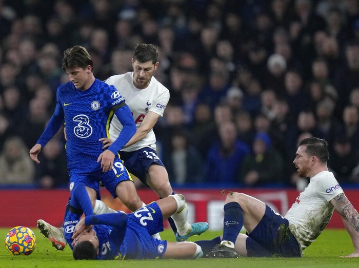 Chelsea's Hakim Ziyech, right, jumps for the ball with Tottenham's Ben Davies during the English Premier League soccer match between Chelsea and Tottenham Hotspur at Stamford Bridge stadium in London, England, Sunday, Jan. 23, 2022. (AP Photo/Kirsty Wigglesworth)