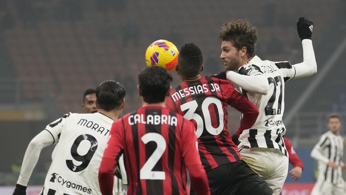 Juventus Manuel Locatelli, right, goes for a header during a Serie A soccer match between AC Milan and Juventus at the San Siro stadium in Milan, Italy, Sunday, Jan. 23, 2022. (AP Photo/Luca Bruno)
