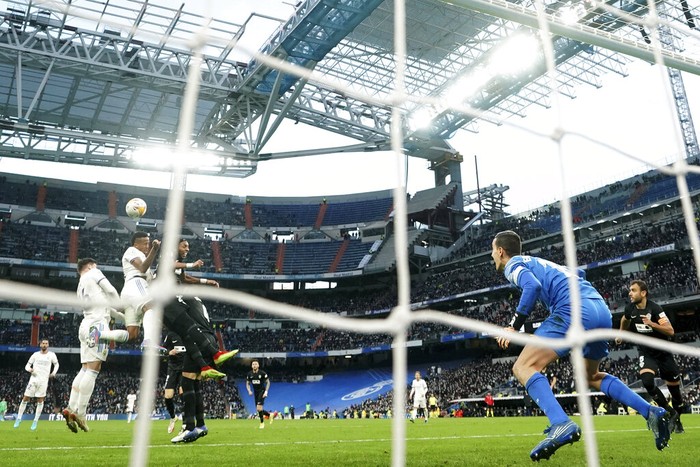 Real Madrid's Eder Militao, third left, heads the ball to score the equalising goal during a Spanish La Liga soccer match between Real Madrid and Elche at the Bernabeu stadium in Madrid, Spain, Sunday, Jan. 23, 2022. (AP Photo/Manu Fernandez)