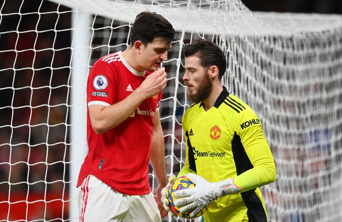 MANCHESTER, ENGLAND - DECEMBER 30: Harry Maguire and David De Gea of Manchester United interact during the Premier League match between Manchester United and Burnley at Old Trafford on December 30, 2021 in Manchester, England. (Photo by Dan Mullan/Getty Images)