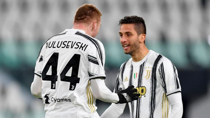 TURIN, ITALY - JANUARY 13: Dejan Kulusevski of Juventus F.C.  celebrates with teammate Rodrigo Bentancur after scoring their teams first goal during the Coppa Italia match between Juventus and Genoa CFC at Allianz Stadium on January 13, 2021 in Turin, Italy. Sporting stadiums around Italy remain under strict restrictions due to the Coronavirus Pandemic as Government social distancing laws prohibit fans inside venues resulting in games being played behind closed doors. (Photo by Valerio Pennicino/Getty Images)