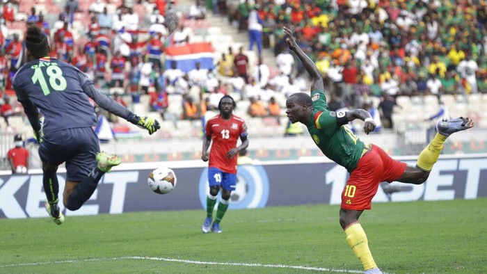 Cameroons Vincent Aboubakar, right, plays a head shot as he fails to score a goal against Gambias goalkeeper Baboucarr Gaye, during the African Cup of Nations 2022 quarter-final soccer match between Gambia and Cameroon at the Japoma Stadium in Douala, Cameroon, Saturday, Jan. 29, 2022. (AP Photo/Sunday Alamba)