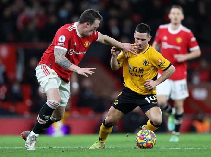 MANCHESTER, ENGLAND - JANUARY 03:  Daniel Podence of Wolverhampton Wanderers is challenged by Phil Jones of Manchester United during the Premier League match between Manchester United and Wolverhampton Wanderers at Old Trafford on January 03, 2022 in Manchester, England. (Photo by Clive Brunskill/Getty Images)