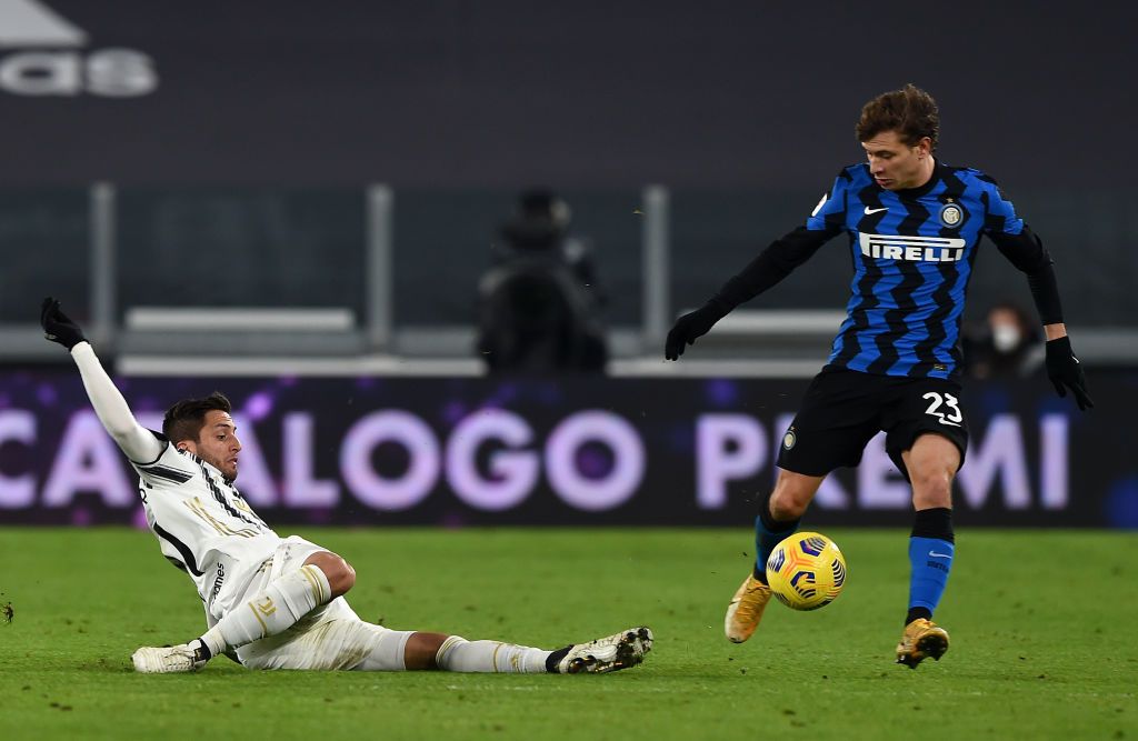 TURIN, ITALY - FEBRUARY 09: Nicolo Barella of FC Internazionale is challenged by Rodrigo Bentancur of Juventus during the Coppa Italia semi-final Juventus and FC Internazionale at Allianz Stadium on February 09, 2021 in Turin, Italy. Sporting stadiums around Italy remain under strict restrictions due to the Coronavirus Pandemic as Government social distancing laws prohibit fans inside venues resulting in games being played behind closed doors. (Photo by Chris Ricco/Getty Images)