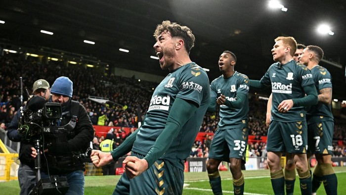 MANCHESTER, ENGLAND - FEBRUARY 04:  Matt Crooks of Middlesbrough celebrates towards the fans after scoring during the Emirates FA Cup Fourth Round match between Manchester United and Middlesbrough at Old Trafford on February 04, 2022 in Manchester, England. (Photo by Clive Mason/Getty Images)