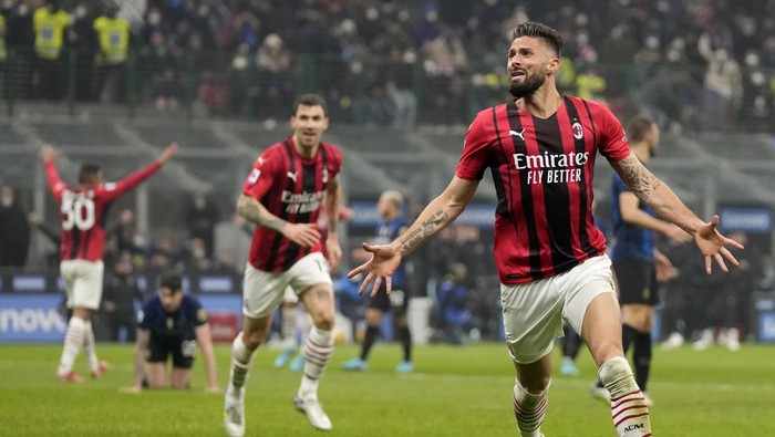 AC Milans Olivier Giroud celebrates after scoring his sides opening goal during the Serie A soccer match between Inter Milan and AC Milan at the San Siro Stadium, in Milan, Italy, Saturday, Feb. 5, 2022. (AP Photo/Antonio Calanni)
