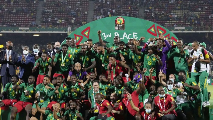 Cameroons players celebrate after receiving their medals at the end of the African Cup of Nations 2022, third place soccer match between Burkina Faso and Cameroon at the Ahmadou Ahidjo stadium in Yaounde, Cameroon, Saturday, Feb. 5, 2022. (AP Photo/Themba Hadebe)