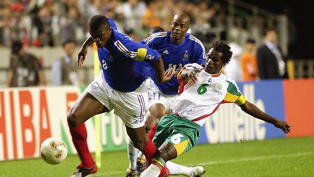 SEOUL - MAY 31:  Marcel Desailly (left) of France is tackled by Aliou Cisse (No.6) of Senegal during the France v Senegal Group A, World Cup Group Stage match played at the Seoul World Cup Stadium, Seoul, South Korea on May 31, 2002. Senegal won the match 1-0. (Photo by Shaun Botterill/Getty Images)