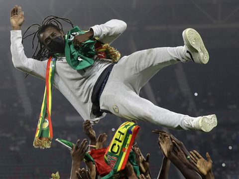 Senegal's players celebrate with Senegal's head coach Aliou Cisse after winning the African Cup of Nations 2022 final soccer match between Senegal and Egypt at the Ahmadou Ahidjo stadium in Yaounde, Cameroon, Sunday, Feb. 6, 2022. (AP Photo/Sunday Alamba)
