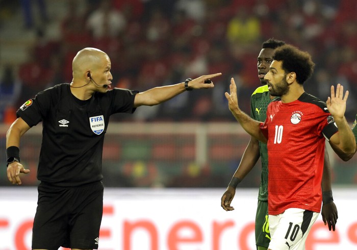 Senegals Kalidou Koulibaly, bottom, kicks the ball as he defends against Egypts Mohamed Salah, right, during the African Cup of Nations 2022 final soccer match between Senegal and Egypt at the Ahmadou Ahidjo stadium in Yaounde, Cameroon, Sunday, Feb. 6, 2022. (AP Photo/Themba Hadebe)