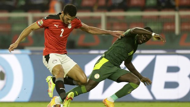Egypt's Mohamed Abdel-Moneim, left, duels for the ball with Senegal's Sadio Mane during the African Cup of Nations 2022 final soccer match between Senegal and Egypt at the Ahmadou Ahidjo stadium in Yaounde, Cameroon, Sunday, Feb. 6, 2022. (AP Photo/Sunday Alamba)