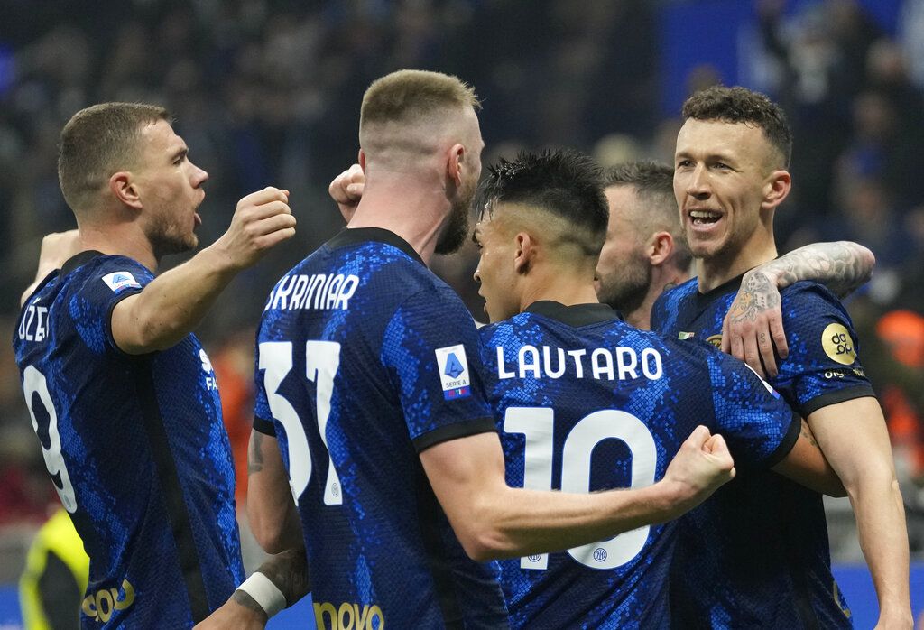 Inter Milan's Ivan Perisic, right, celebrates with teammates after scoring his side's opening goal during the Serie A soccer match between Inter Milan and AC Milan at the San Siro Stadium, in Milan, Italy, Saturday, Feb. 5, 2022. (AP Photo/Antonio Calanni)