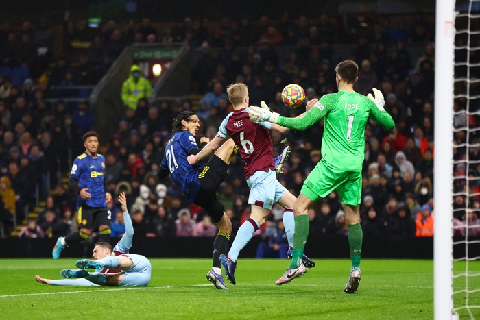 BURNLEY, ENGLAND - FEBRUARY 08: Edinson Cavani of Manchester United is challenged by Ben Mee of Burnley in the box during the Premier League match between Burnley and Manchester United at Turf Moor on February 08, 2022 in Burnley, England. (Photo by Clive Brunskill/Getty Images)