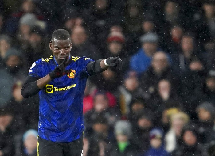 Manchester Uniteds Paul Pogba celebrates after scoring his sides opening goal during the English Premier League soccer match between Burnley and Manchester United at Turf Moor, in Burnley, England, Tuesday, Feb. 8, 2022. (AP Photo/Jon Super)