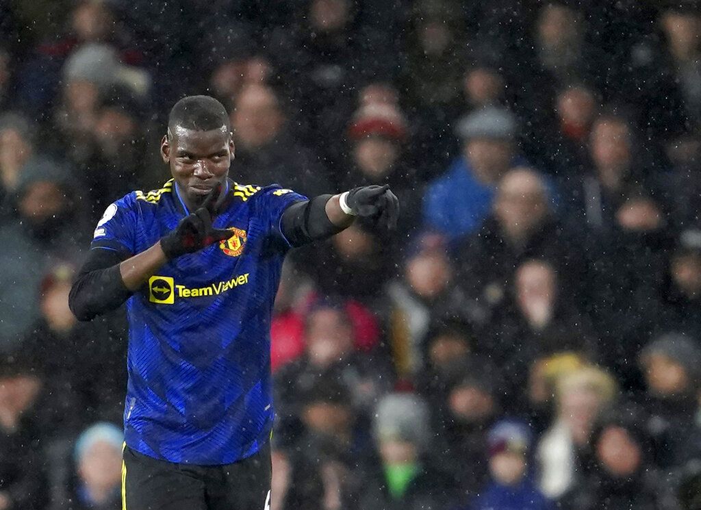 Manchester United's Paul Pogba celebrates after scoring his side's opening goal during the English Premier League soccer match between Burnley and Manchester United at Turf Moor, in Burnley, England, Tuesday, Feb. 8, 2022. (AP Photo/Jon Super)