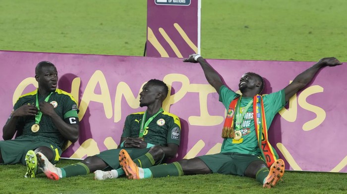Senegals Kalidou Koulibaly, left, and teammates Adrissa Gana Gueye and Sadio Mane celebrate after winning the African Cup of Nations 2022 final soccer match against Egypt at the Ahmadou Ahidjo stadium in Yaounde, Cameroon, Sunday, Feb. 6, 2022. (AP Photo/Themba Hadebe)