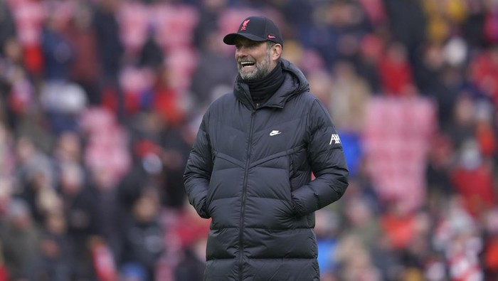 Liverpools manager Jurgen Klopp smiles during the warm-up before the FA Cup fourth round soccer match between Liverpool and Cardiff City at Anfield stadium in Liverpool, England, Sunday, Feb. 6, 2022. (AP Photo/Jon Super)