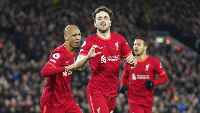 Liverpools Diogo Jota, center, celebrates with his teammate Fabinho, left, after scoring his sides opening goal during the English Premier League soccer match between Liverpool and Leicester City at Anfield stadium in Liverpool, England, Thursday, Feb. 10, 2022. (AP Photo/Jon Super)