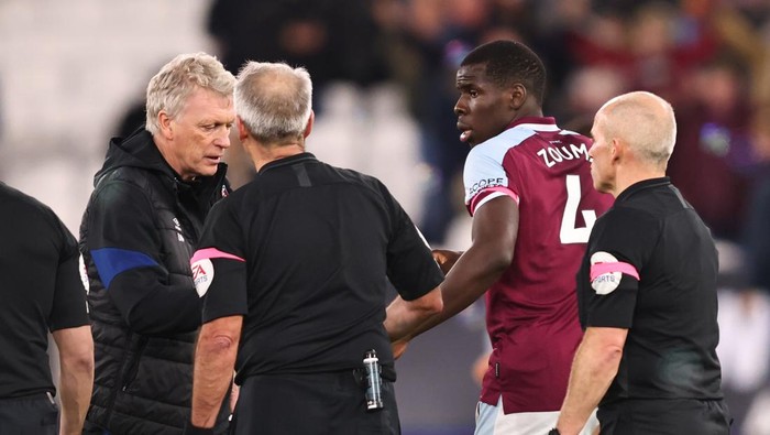 LONDON, ENGLAND - FEBRUARY 08:  Kurt Zouma of West Ham United looks on as manager David Moyes speaks to the match officials during the Premier League match between West Ham United and Watford at London Stadium on February 8, 2022 in London, United Kingdom. (Photo by Marc Atkins/Getty Images)