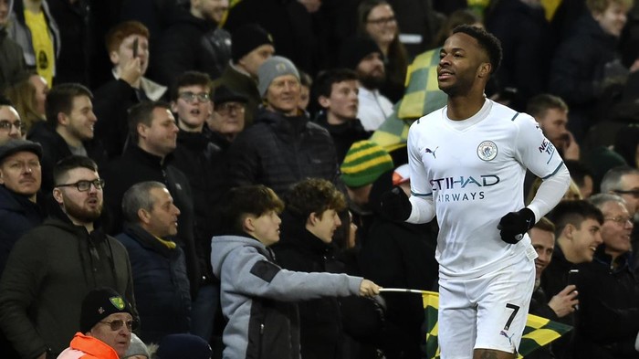 Manchester Citys Raheem Sterling celebrates after scoring his sides fourth goal during the English Premier League soccer match between Norwich City and Manchester City at Carrow Road Stadium in Norwich, England, Saturday, Feb. 12, 2022. (AP Photo/Rui Vieira)