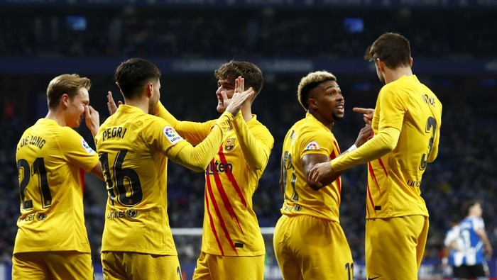 Barcelonas Pedri, 2nd left, celebrates after scoring the opening goal during a Spanish La Liga soccer match between RCD Espanyol and Barcelona at the Cornella-El Prat stadium in Barcelona, Spain, Sunday, Feb. 13, 2022. (AP Photo/Joan Monfort)