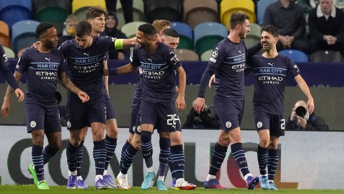 Manchester City players celebrate the second goal of their team during the Champions League round of 16 soccer match between Sporting CP and Manchester City at the Alvalade stadium in Lisbon, Portugal, Tuesday, Feb. 15, 2022. (AP Photo/Armando Franca)