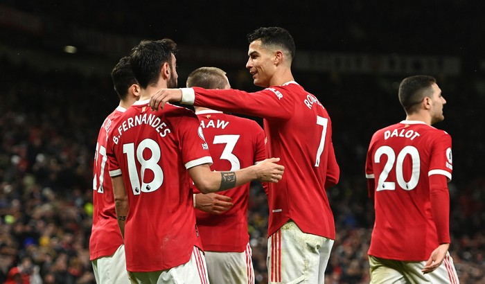 MANCHESTER, ENGLAND - FEBRUARY 15: Bruno Fernandes celebrates with Cristiano Ronaldo of Manchester United after scoring their teams first goal during the Premier League match between Manchester United and Brighton & Hove Albion at Old Trafford on February 15, 2022 in Manchester, England. (Photo by Gareth Copley/Getty Images)