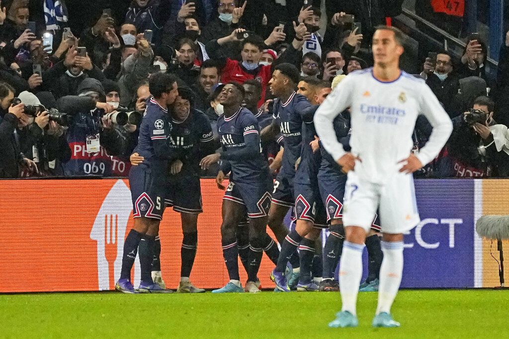 PSG's Kylian Mbappe, second left, is congratulated by teammates after scoring his side opening goal during the Champions League round of 16, first leg, soccer match Paris Saint-Germain against Real Madrid at the Parc des Princes stadium in Paris, Tuesday, Feb.15, 2022. (AP Photo/Michel Euler)