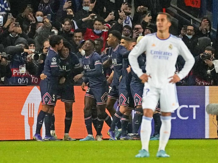 PSG's Kylian Mbappe, second left, is congratulated by teammates after scoring his side opening goal during the Champions League round of 16, first leg, soccer match Paris Saint-Germain against Real Madrid at the Parc des Princes stadium in Paris, Tuesday, Feb.15, 2022. (AP Photo/Michel Euler)