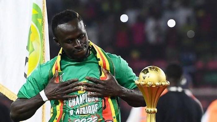Senegals forward Sadio Mane looks at the trophy prior to the ceremony after winning after the Africa Cup of Nations (CAN) 2021 final football match between Senegal and Egypt at Stade dOlembe in Yaounde on February 6, 2022. (Photo by CHARLY TRIBALLEAU / AFP)