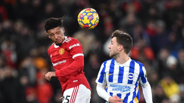 Soccer Football - Premier League - Manchester United v Brighton & Hove Albion - Old Trafford, Manchester, Britain - February 15, 2022  Manchester United's Jadon Sancho in action with Brighton & Hove Albion's Joel Veltman REUTERS/Peter Powell EDITORIAL USE ONLY. No use with unauthorized audio, video, data, fixture lists, club/league logos or 'live' services. Online in-match use limited to 75 images, no video emulation. No use in betting, games or single club /league/player publications.  Please contact your account representative for further details.