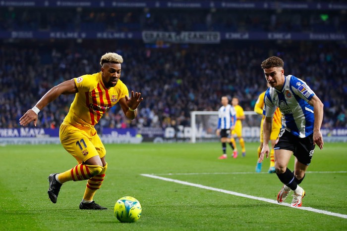BARCELONA, SPAIN - FEBRUARY 13: Adama Traore of FC Barcelona challenges for the ball against Adria Pedrosa of Espanyol during the LaLiga Santander match between RCD Espanyol and FC Barcelona at RCDE Stadium on February 13, 2022 in Barcelona, Spain. (Photo by Eric Alonso/Getty Images)
