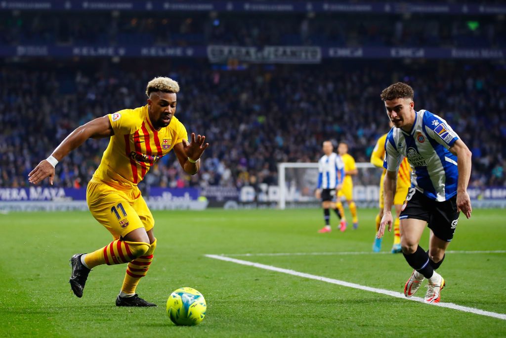 BARCELONA, SPAIN - FEBRUARY 13: Adama Traore of FC Barcelona challenges for the ball against Adria Pedrosa of Espanyol during the LaLiga Santander match between RCD Espanyol and FC Barcelona at RCDE Stadium on February 13, 2022 in Barcelona, Spain. (Photo by Eric Alonso/Getty Images)