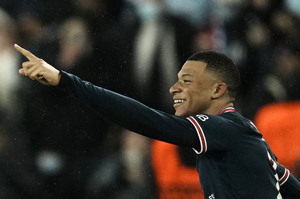 PSG's Kylian Mbappe celebrates after scoring his side's opening goal during the Champions League, round of 16, first leg soccer match between Paris Saint Germain and Real Madrid at the Parc des Princes stadium, in Paris, France, Tuesday, Feb. 15, 2022. (AP Photo/Thibault Camus)