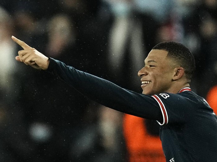 PSG's Kylian Mbappe celebrates after scoring his side's opening goal during the Champions League, round of 16, first leg soccer match between Paris Saint Germain and Real Madrid at the Parc des Princes stadium, in Paris, France, Tuesday, Feb. 15, 2022. (AP Photo/Thibault Camus)