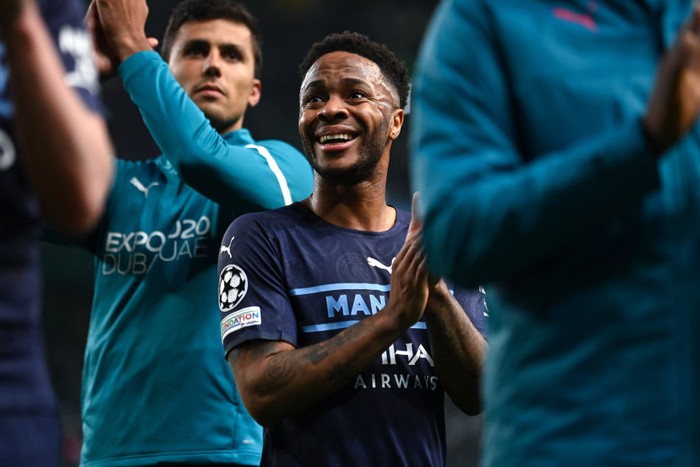 LISBON, PORTUGAL - FEBRUARY 15: Raheem Sterling of Manchester City applauds the travelling fanss at the end of  the UEFA Champions League Round Of Sixteen Leg One match between Sporting CP and Manchester City at Estadio Jose Alvalade on February 15, 2022 in Lisbon, Portugal. (Photo by Mike Hewitt/Getty Images)