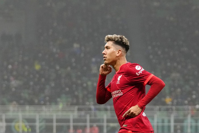 Liverpools Roberto Firmino celebrates after scoring his sides opening goal during the Champions League, round of 16, first leg soccer match between Inter Milan and Liverpool at the San Siro stadium in Milan, Italy, Wednesday, Feb. 16, 2022. (AP Photo/Antonio Calanni)