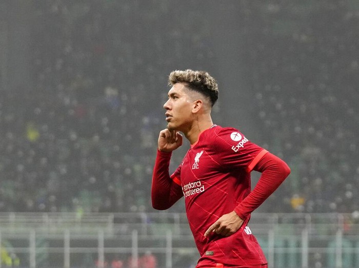 Liverpool's Roberto Firmino celebrates after scoring his side's opening goal during the Champions League, round of 16, first leg soccer match between Inter Milan and Liverpool at the San Siro stadium in Milan, Italy, Wednesday, Feb. 16, 2022. (AP Photo/Antonio Calanni)