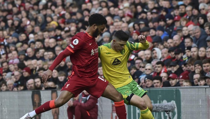 Norwich Citys Milot Rashica, right, vies for the ball with Liverpools Joe Gomez during the English Premier League soccer match between Liverpool and Norwich City and at Anfield stadium in Liverpool, England, Saturday, Feb. 19, 2022. (AP Photo/Rui Vieira)