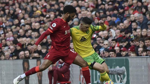 Norwich City's Milot Rashica, right, vies for the ball with Liverpool's Joe Gomez during the English Premier League soccer match between Liverpool and Norwich City and at Anfield stadium in Liverpool, England, Saturday, Feb. 19, 2022. (AP Photo/Rui Vieira)