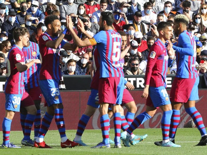 Barcelona's Pierre-Emerick Aubameyang, 2nd left, celebrates with team mates after scoring the opening goal during a Spanish La Liga soccer match between Valencia and Barcelona at the Mestalla stadium in Valencia, Spain, Sunday, Feb. 20, 2022. (AP Photo/Alberto Saiz)