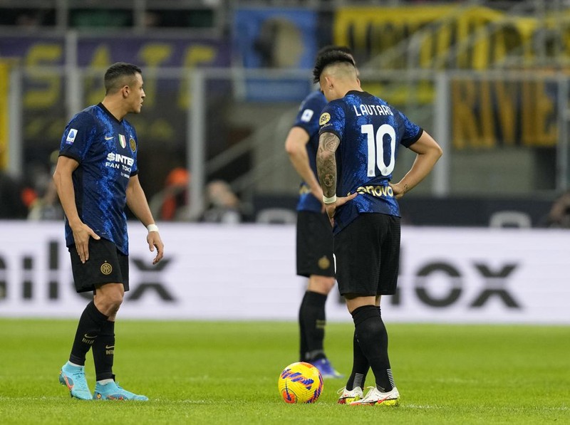 Inter Milan's Lautaro Martinez, right, reacts after Sassuolo's Giacomo Raspadori scored his side's opening goal during the Serie A soccer match between Inter Milan and Sassuolo at the San Siro Stadium, in Milan, Italy, Sunday, Feb. 20, 2022. (AP Photo/Antonio Calanni)